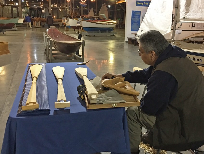 Photo of Puyallup Tribal member carving paddles.